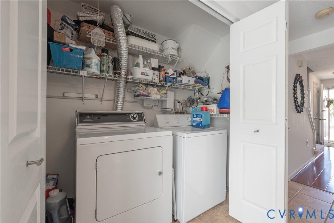 Dedicated laundry area with upper wire shelving for storage