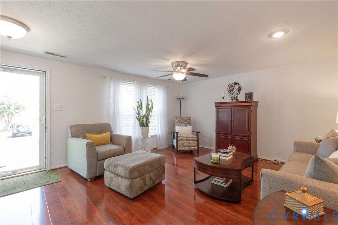 Wood-finish flooring throughout, ceiling fan with integrated lighting, recessed lighting, and a glass-paneled entry door