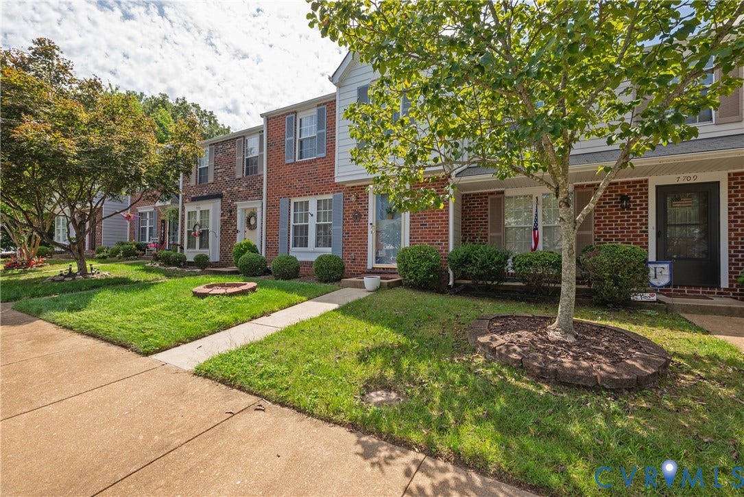 Brick exterior, established landscaping, front lawn, sidewalk access, decorative window shutters