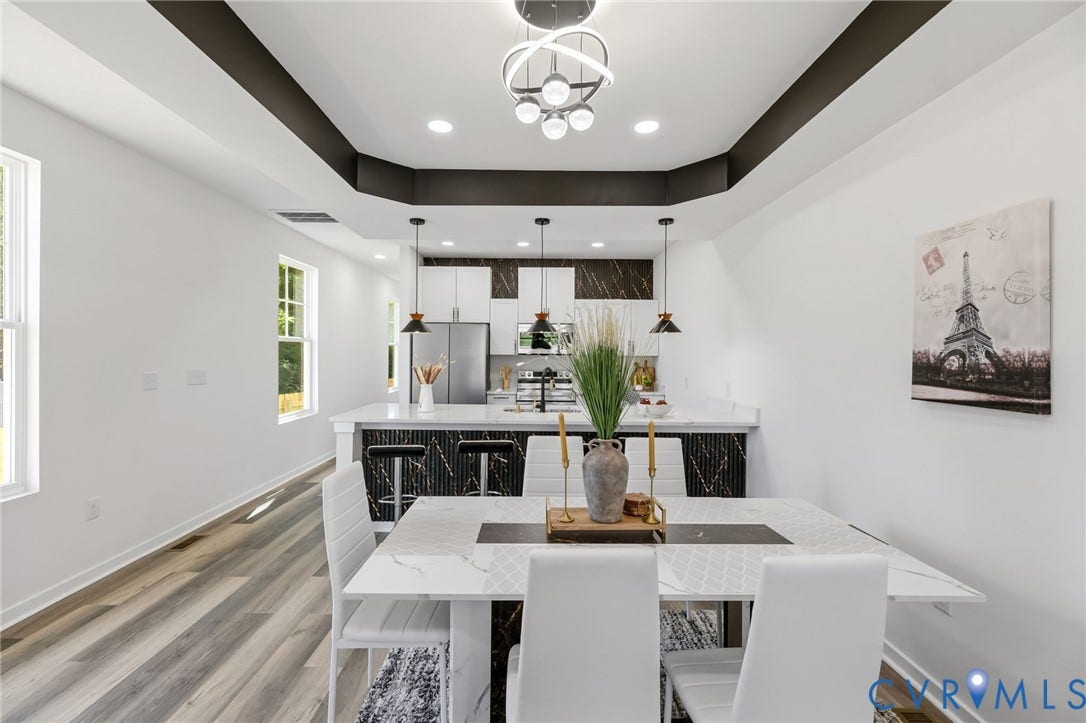 516 S South Street, Myers, Petersburg, VA 23803 Open concept living area featuring wood-finish flooring, recessed lighting, and a modern dining chandelier