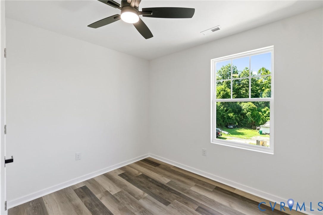 516 S South Street, Myers, Petersburg, VA 23803 Wood-finish flooring, white walls, white trim, single-pane window, and a ceiling fan with integrated lighting