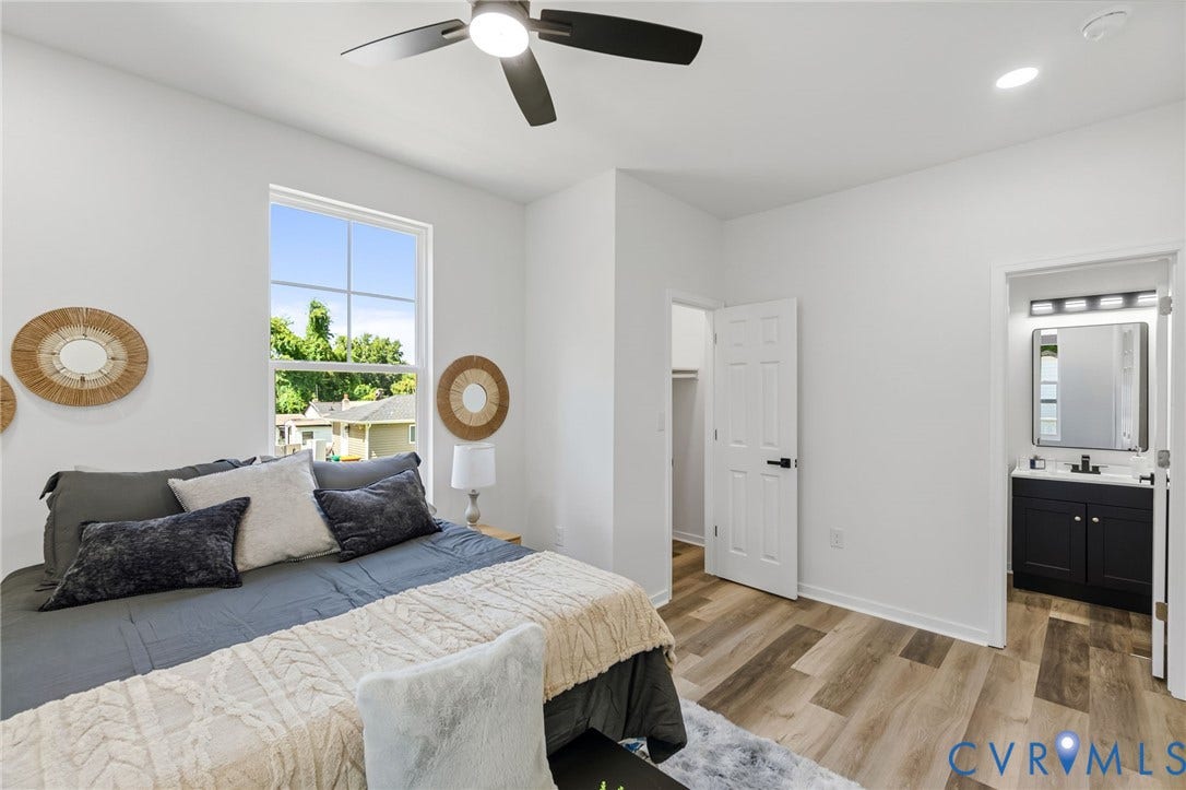 516 S South Street, Myers, Petersburg, VA 23803 Spacious room featuring wood-finish flooring, a ceiling fan with integrated lighting, and a large window with grilles