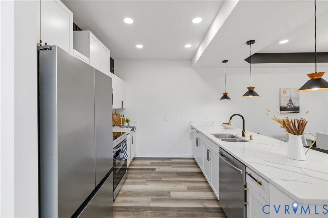 516 S South Street, Myers, Petersburg, VA 23803 Modern kitchen featuring stainless steel appliances, white cabinetry, wood-finish flooring, recessed lighting, and an island with a dual-basin sink and pendant lights