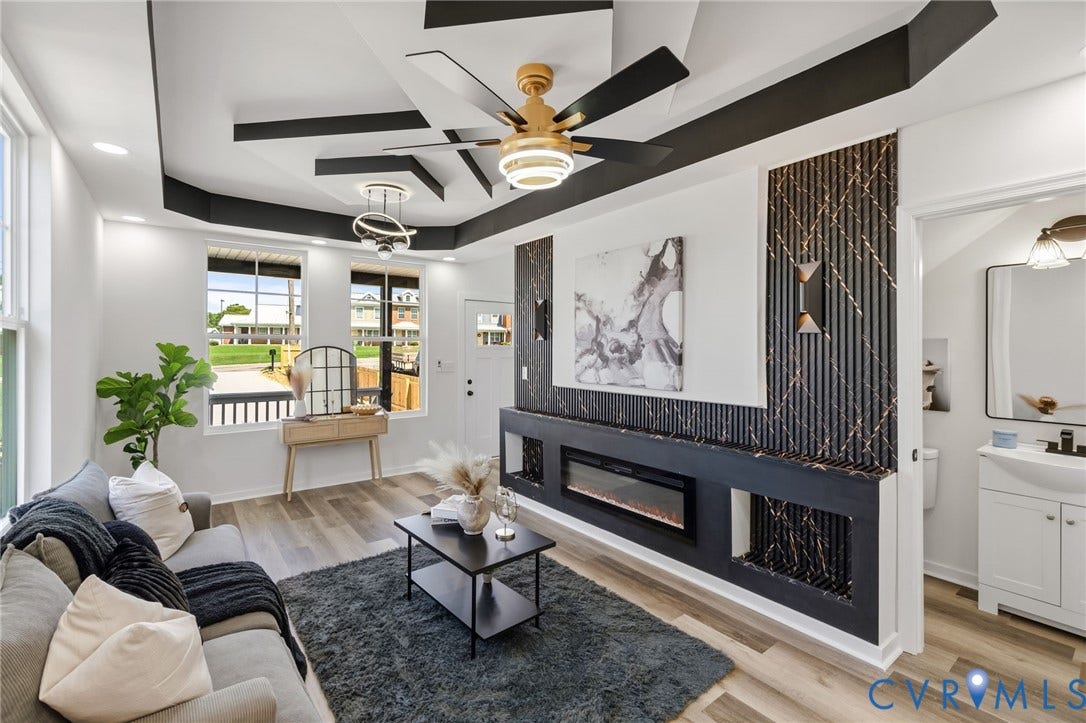 516 S South Street, Myers, Petersburg, VA 23803 Tray ceiling with recessed lighting and a ceiling fan, wood-finish flooring, and a built-in electric fireplace