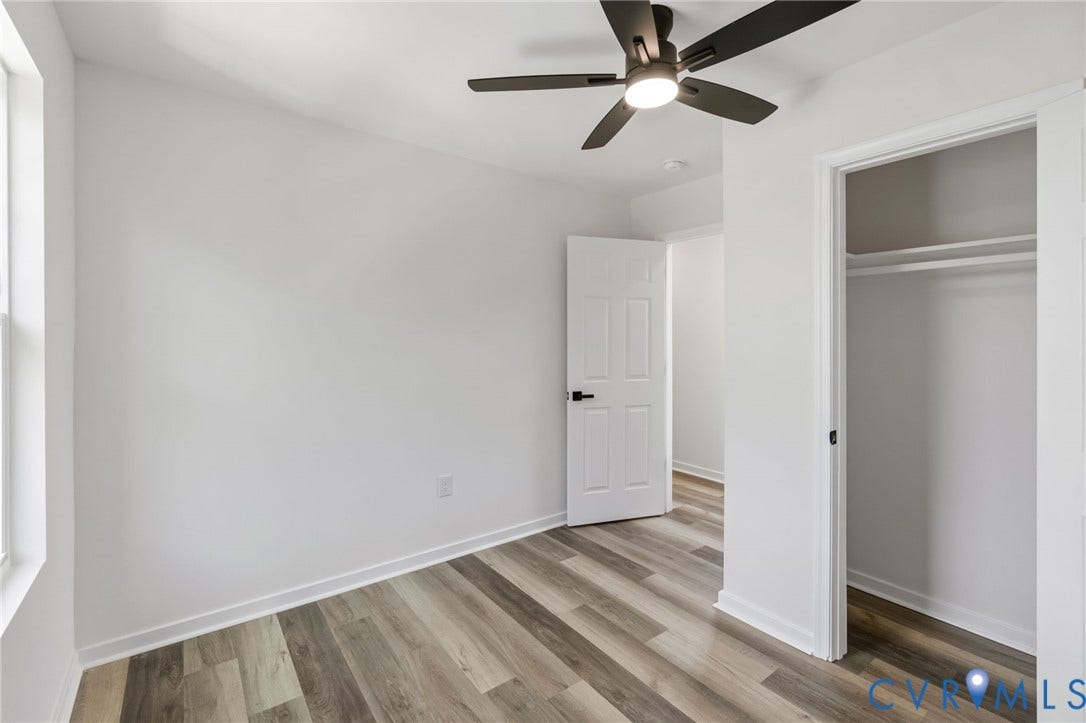 516 S South Street, Myers, Petersburg, VA 23803 Wood-finish flooring, white walls, ceiling fan with integrated lighting, window, and a built-in closet with shelving and hanging rod