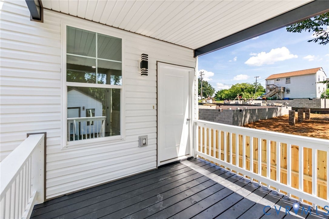 516 S South Street, Myers, Petersburg, VA 23803 Covered porch with wood-finish flooring, white railing, and white siding