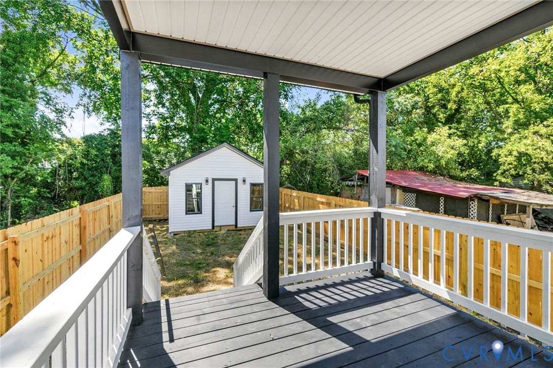 516 S South Street, Myers, Petersburg, VA 23803 Covered deck with dark wood-finish flooring, white railing, and dark support beams