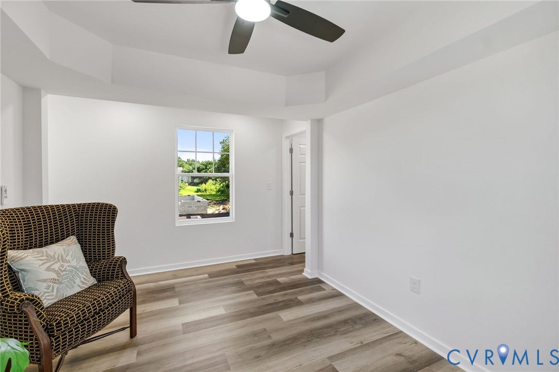 516 S South Street, Myers, Petersburg, VA 23803 Wood-finish flooring, white walls, ceiling fan with integrated lighting, and a single window