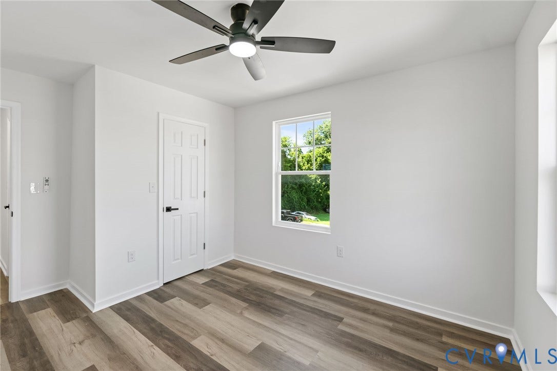 516 S South Street, Myers, Petersburg, VA 23803 Room featuring wood-finish flooring, a ceiling fan with light, and a window providing exterior scenery