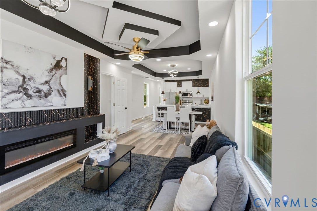 516 S South Street, Myers, Petersburg, VA 23803 Open-concept living space featuring wood-finish flooring, a contemporary ceiling fan, recessed lighting, and an electric fireplace with a black surround
