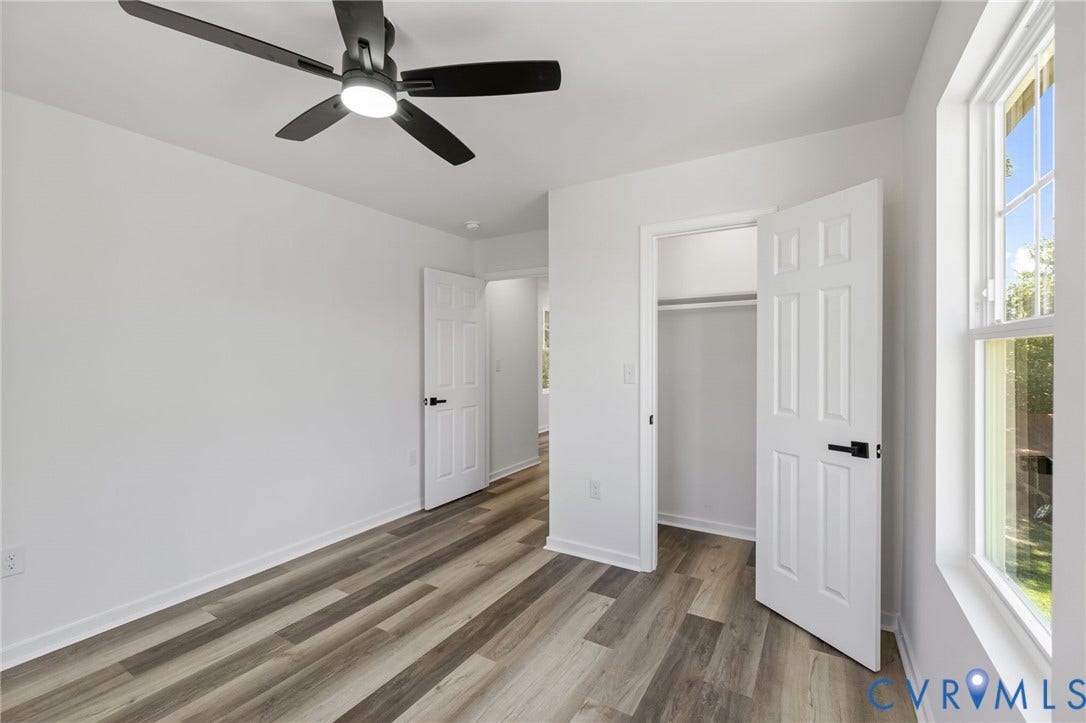 516 S South Street, Myers, Petersburg, VA 23803 Spacious room featuring wood-finish flooring, white walls, and a ceiling fan with integrated lighting