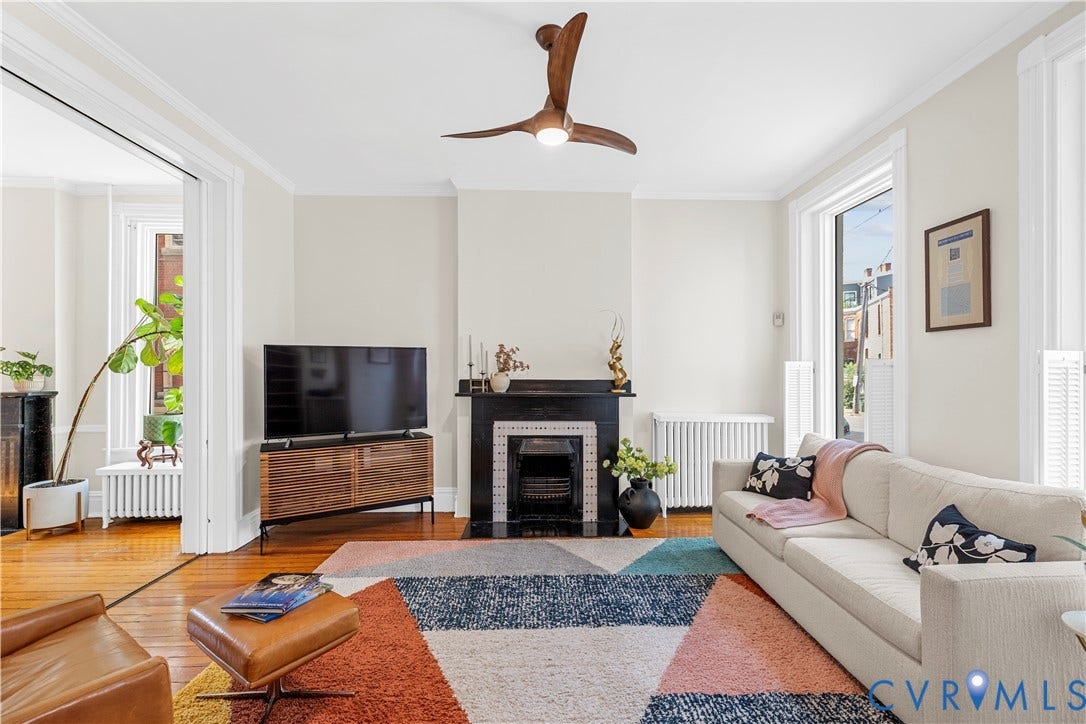 109 N Morris Street, The Fan, Richmond, VA 23220 Hardwood flooring, crown molding, a decorative fireplace with a tile surround, and an overhead ceiling fan with lighting