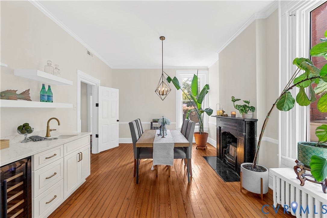 109 N Morris Street, The Fan, Richmond, VA 23220 Hardwood flooring, crown molding, built-in wet bar with wine cooler, black marble fireplace, and elegant pendant lighting