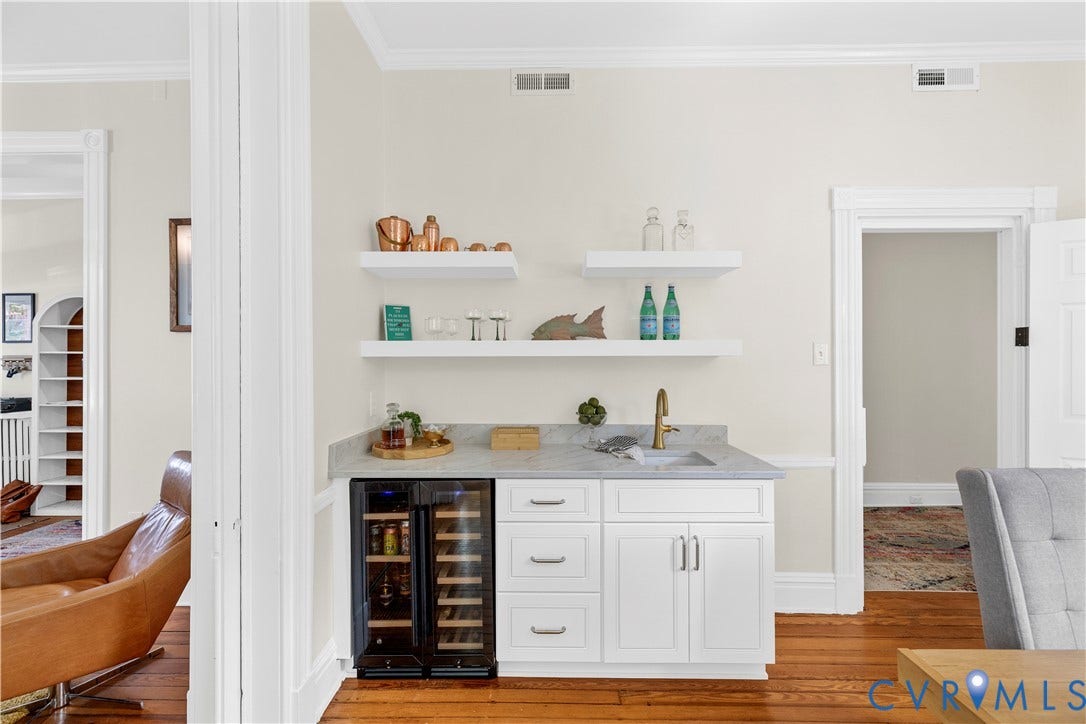 109 N Morris Street, The Fan, Richmond, VA 23220 Built-in beverage station featuring white cabinetry, a stone countertop with an undermount sink, and two integrated beverage refrigerators