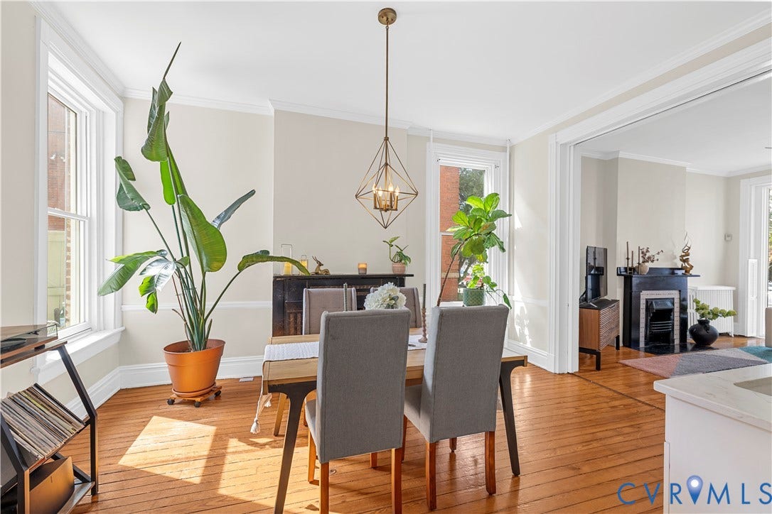 109 N Morris Street, The Fan, Richmond, VA 23220 Hardwood flooring, crown molding, a decorative fireplace, and a geometric chandelier