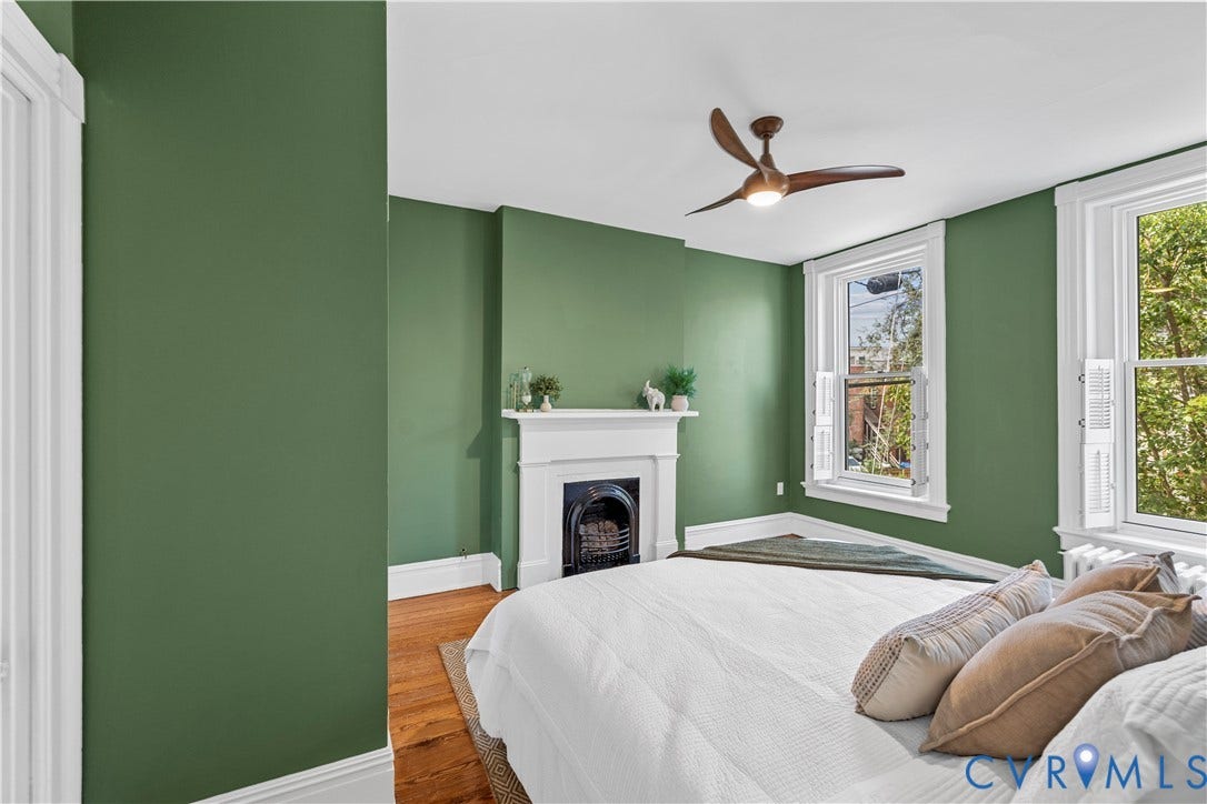 109 N Morris Street, The Fan, Richmond, VA 23220 Hardwood flooring, fireplace with mantel, ceiling fan with integrated lighting, and multiple windows with white shutters