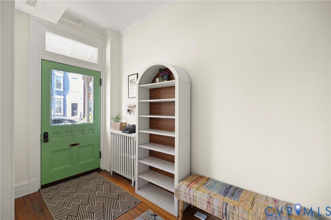 109 N Morris Street, The Fan, Richmond, VA 23220 Hardwood flooring, painted paneled door with transom window, white built-in shelving, and white wall finishes