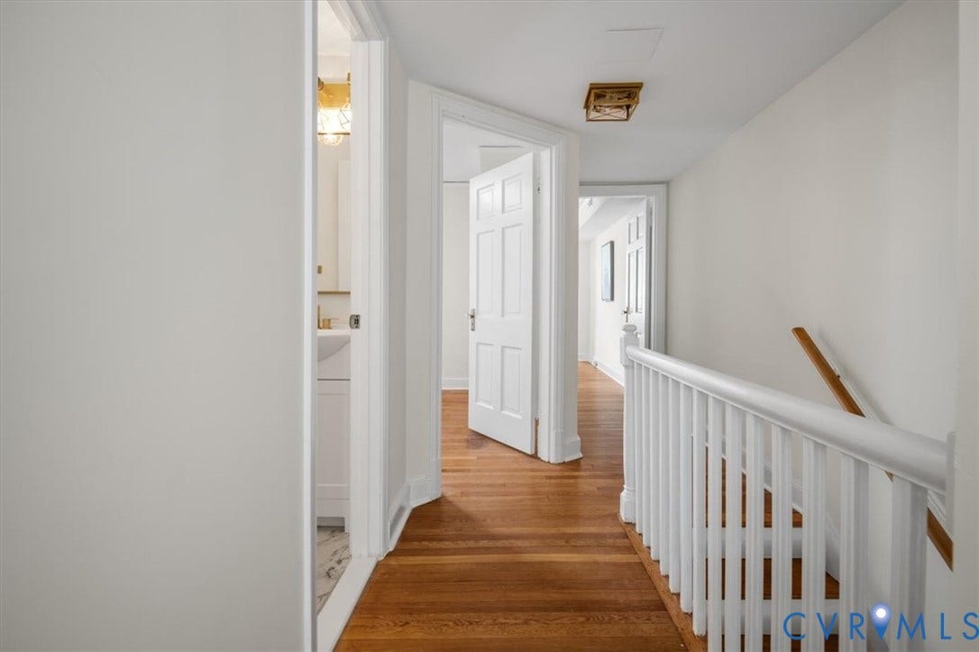 3510 Hanover Avenue, Museum District, Richmond, VA 23221 Hardwood flooring, painted white walls, white paneled interior doors, white spindle railing, and a light-toned wood handrail