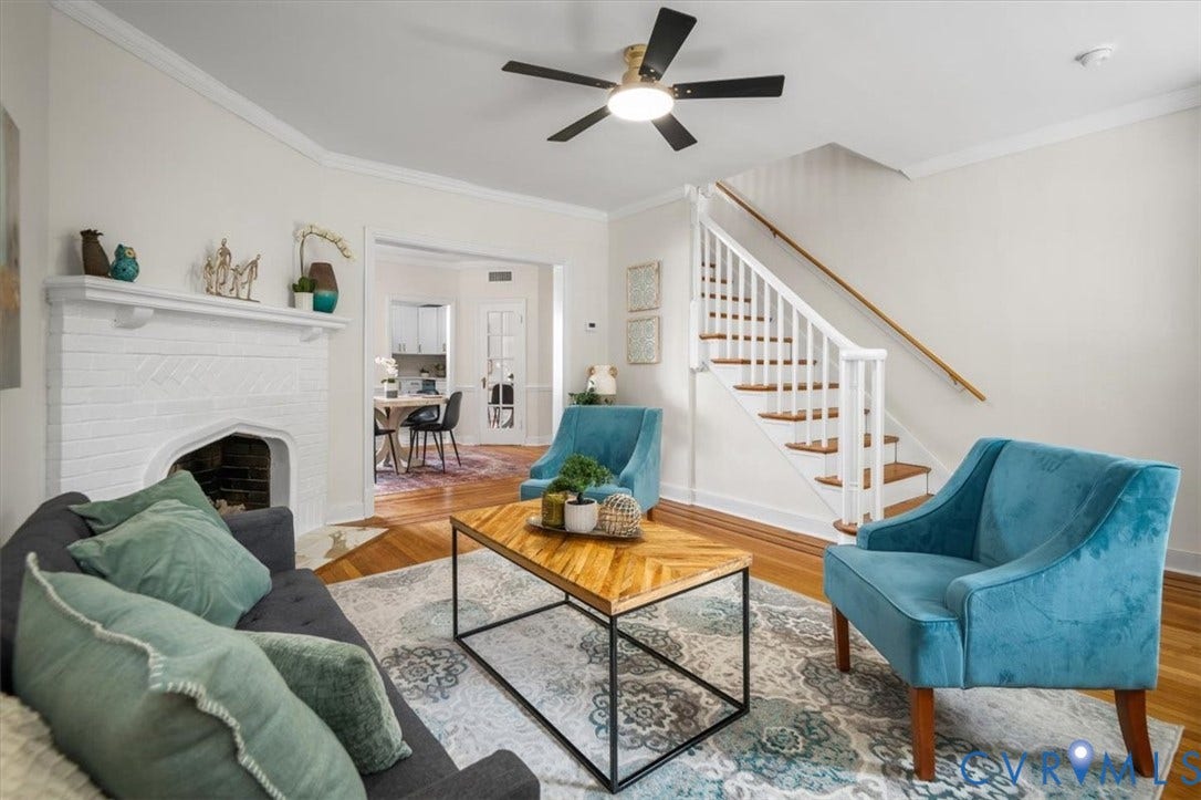 3510 Hanover Avenue, Museum District, Richmond, VA 23221 Living area featuring wood-finish flooring, a white brick fireplace with mantel, and a multi-blade ceiling fan