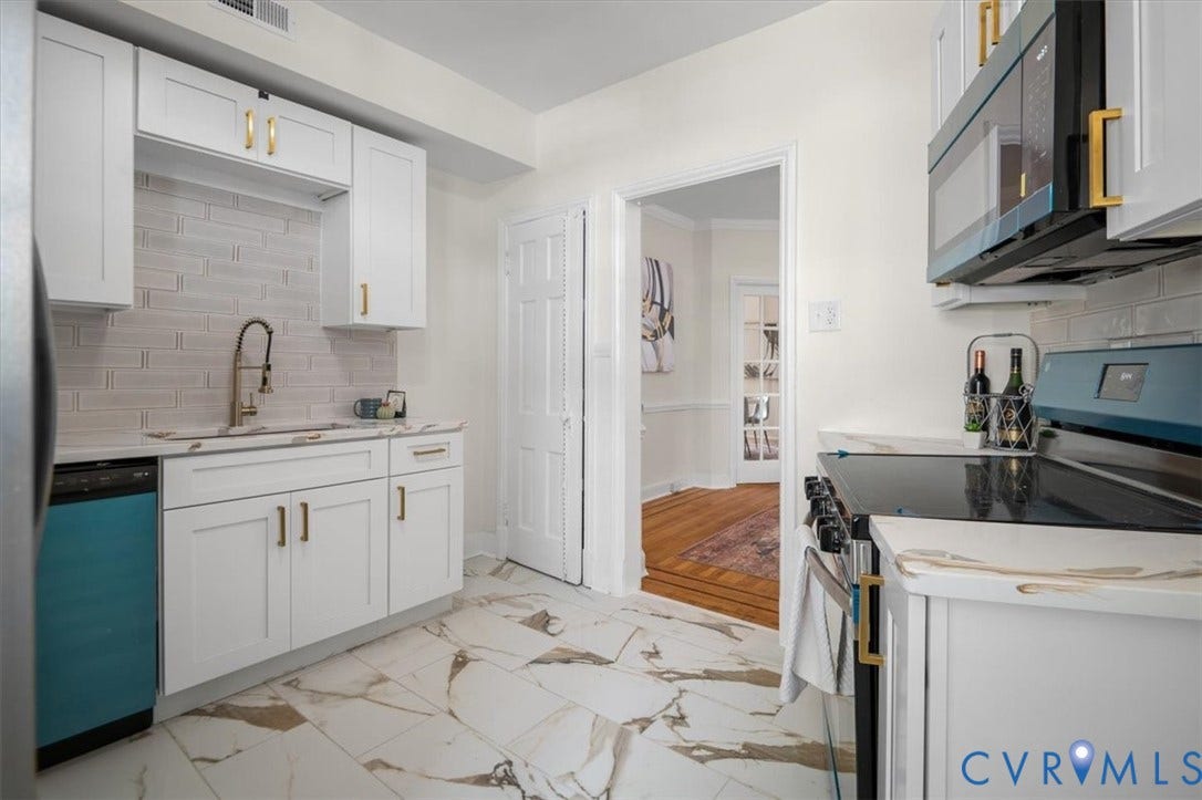 3510 Hanover Avenue, Museum District, Richmond, VA 23221 Updated kitchen featuring white shaker cabinetry, patterned tile flooring, a tile backsplash, and stainless steel appliances