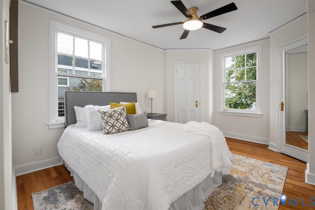 3510 Hanover Avenue, Museum District, Richmond, VA 23221 Hardwood flooring, two large windows, white paneled doors, ceiling fan with integrated lighting, and a full-length mirrored door