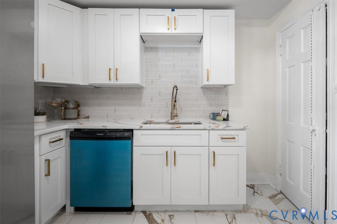 3510 Hanover Avenue, Museum District, Richmond, VA 23221 White shaker-style cabinetry with gold-tone hardware, white subway tile backsplash, white countertop with veining, and a stainless steel faucet