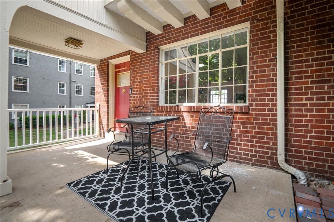 3510 Hanover Avenue, Museum District, Richmond, VA 23221 Covered porch with exposed brick, white railing, and a red entry door