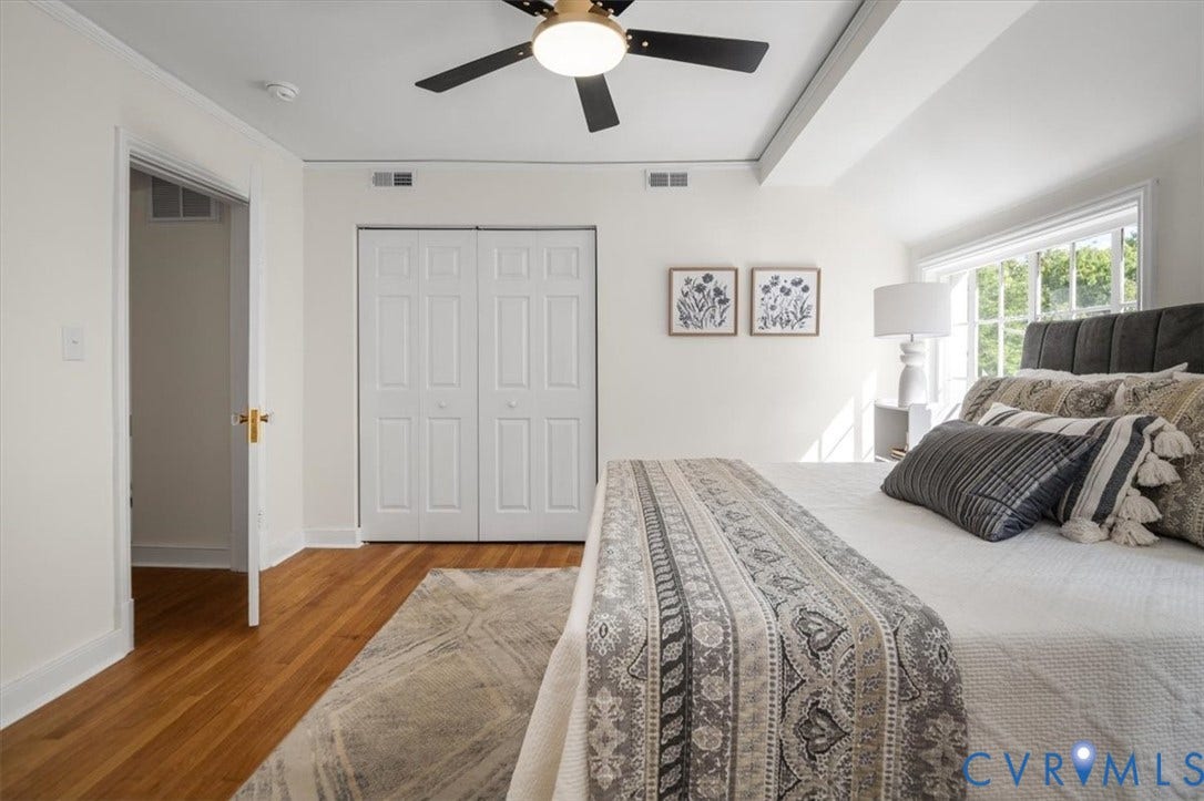 3510 Hanover Avenue, Museum District, Richmond, VA 23221 Hardwood flooring, painted white walls, white bi-fold closet doors, and an attached ceiling fan
