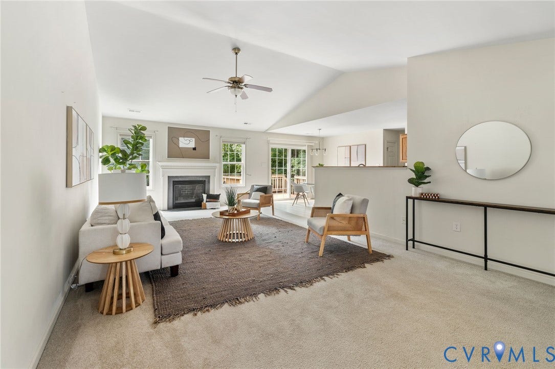 3173 Poplar View Place, Ashley Forest, Chester, VA 23831 Carpeted living area featuring a vaulted ceiling with a ceiling fan, a fireplace with a white mantel, and a sliding glass door