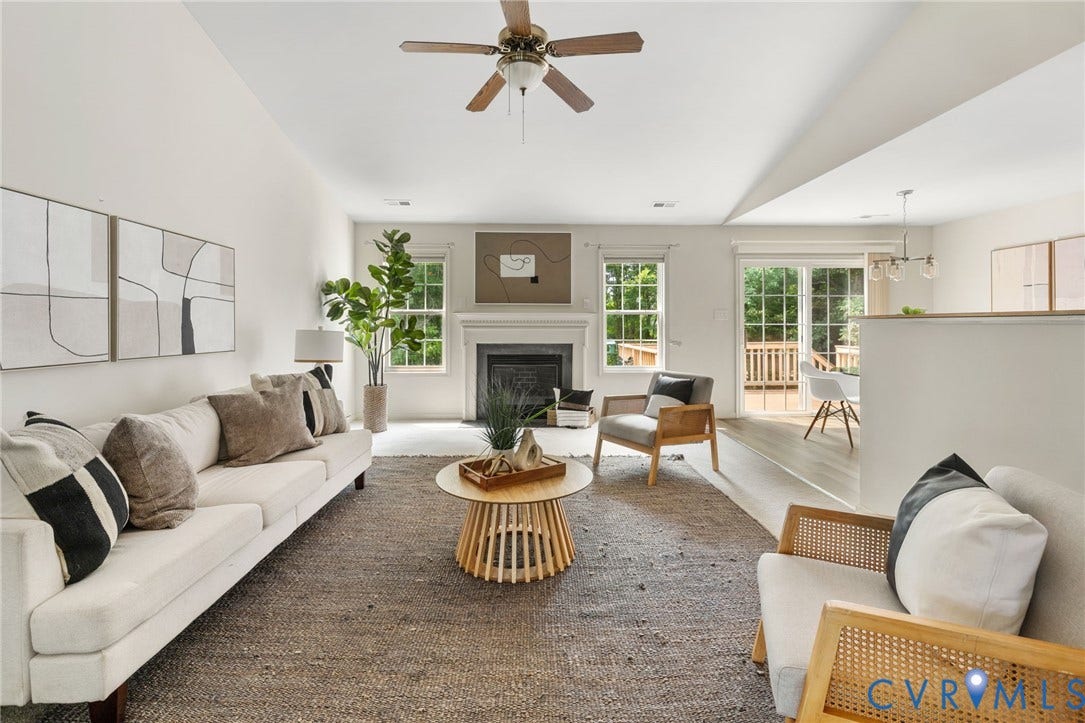 3173 Poplar View Place, Ashley Forest, Chester, VA 23831 Vaulted ceiling with a ceiling fan, fireplace with a mantel, multiple windows, and sliding glass doors opening to an outdoor deck