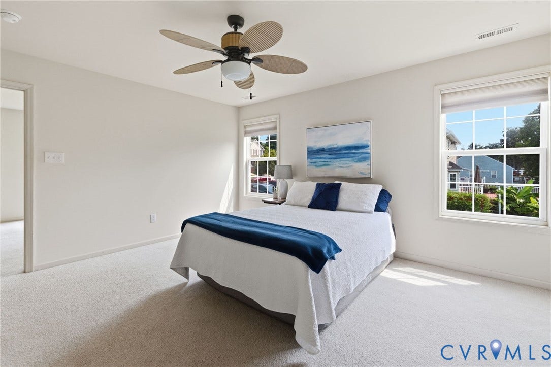 3173 Poplar View Place, Ashley Forest, Chester, VA 23831 Light-filled room featuring neutral wall tones, plush carpeting, a ceiling fan with woven blades, and multiple windows
