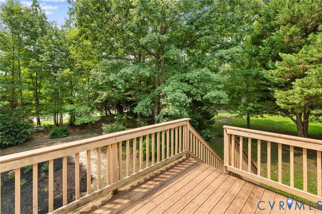 3173 Poplar View Place, Ashley Forest, Chester, VA 23831 Wood-tone deck with railing and stairs, surrounded by mature trees and natural landscaping