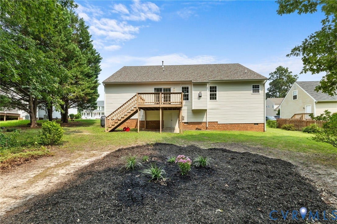 3173 Poplar View Place, Ashley Forest, Chester, VA 23831 Rear exterior featuring light-colored siding, a multi-level wooden deck with stairs, and a gabled roof