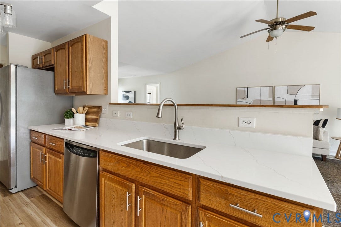 3173 Poplar View Place, Ashley Forest, Chester, VA 23831 Kitchen featuring stainless steel appliances, wood-finish cabinetry, a stainless steel sink, and light-toned countertops