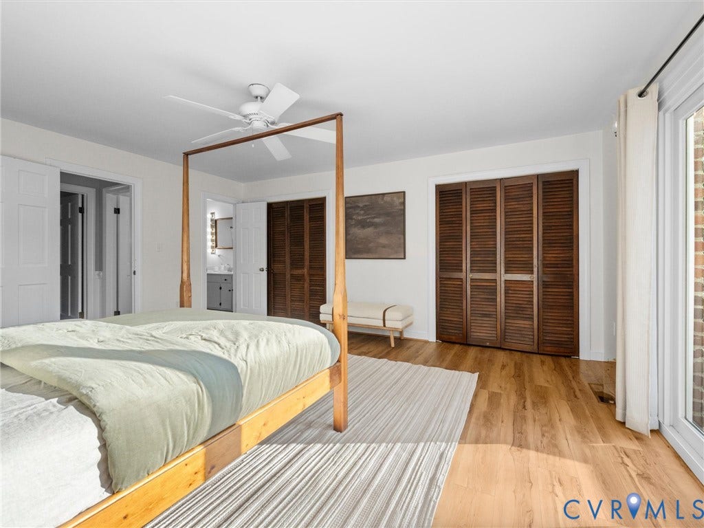 Wood-finish flooring, white walls, and a ceiling fan