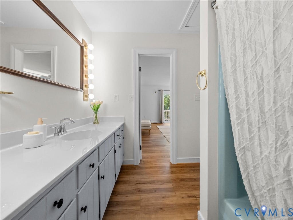 Long vanity with an integrated sink, polished chrome faucet, and ample storage cabinetry