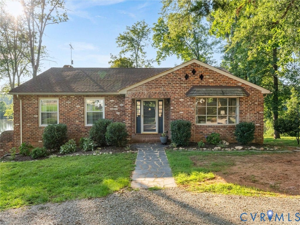 Brick exterior with a gabled roof and a bay window