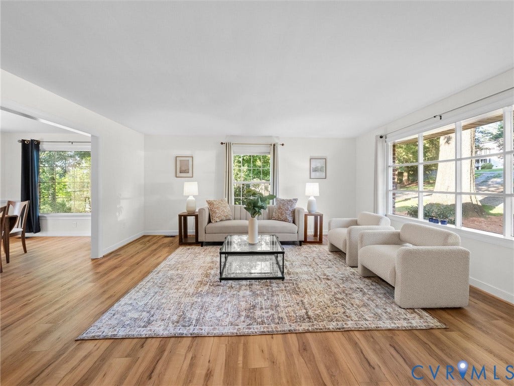 Wood-finish flooring throughout, bright white wall finishes, and expansive windows