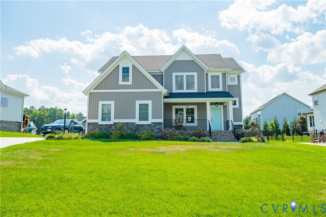 Two-story residence with gray siding and white trim accents