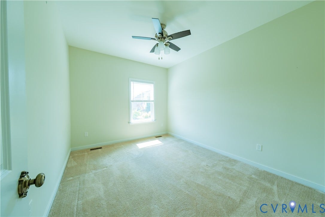 Carpeted flooring, single window, ceiling fan, vaulted ceiling
