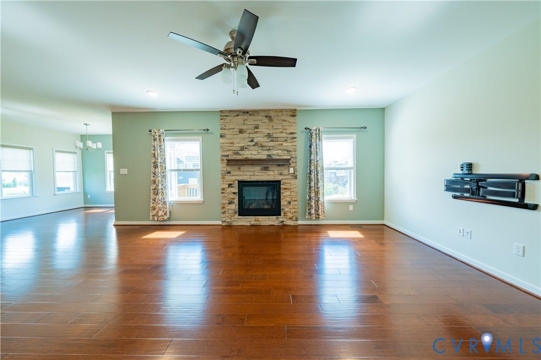 Hardwood-finish flooring, recessed lighting, and a ceiling fan
