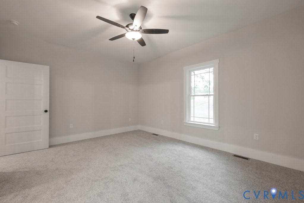 Lot 1A Tabscott Road, Columbia, VA 23038 Carpeted room with a ceiling fan light fixture, five-panel interior door, baseboard trim, and a double-hung window with grilles