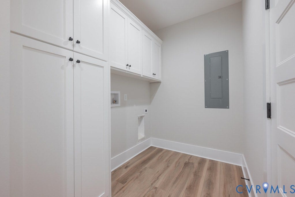 Lot 1A Tabscott Road, Columbia, VA 23038 Laundry room featuring extensive white cabinetry, wood-finish flooring, and white baseboards