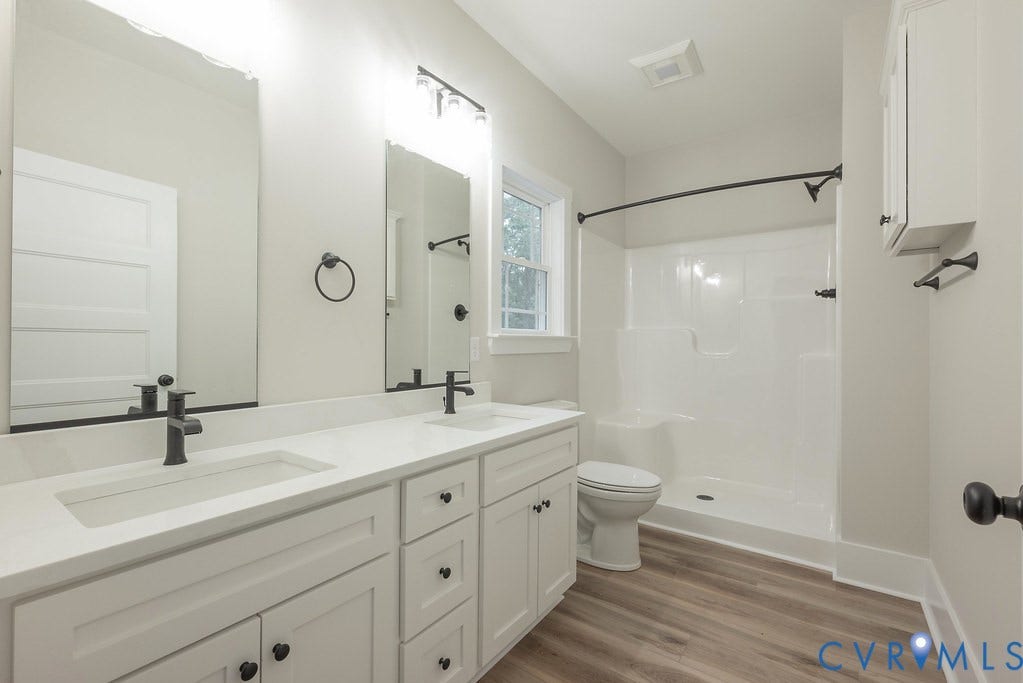 Lot 1A Tabscott Road, Columbia, VA 23038 Double vanity with integrated sinks, white cabinetry, quartz-finish countertop, and matte black fixtures