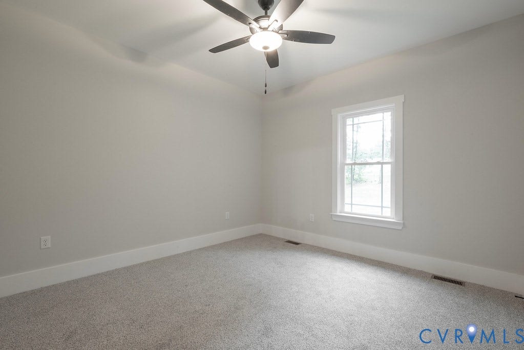 Lot 1A Tabscott Road, Columbia, VA 23038 Carpeted room featuring a ceiling fan with integrated lighting, a tray ceiling detail, a double-hung window with white trim, and baseboard molding