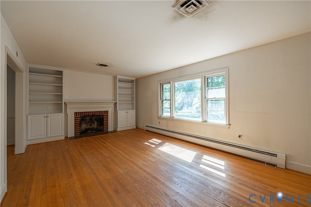 4532 Arrowhead Road, Statford Hills / Oxford, Richmond, VA 23235 Hardwood flooring, brick fireplace with a white mantel, built-in shelving, and large windows