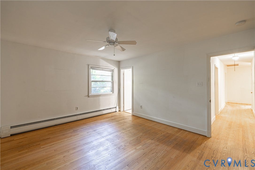 4532 Arrowhead Road, Statford Hills / Oxford, Richmond, VA 23235 Spacious room featuring warm wood-finish flooring, ceiling fan with integrated lighting, baseboard heating, and abundant natural light from a large window