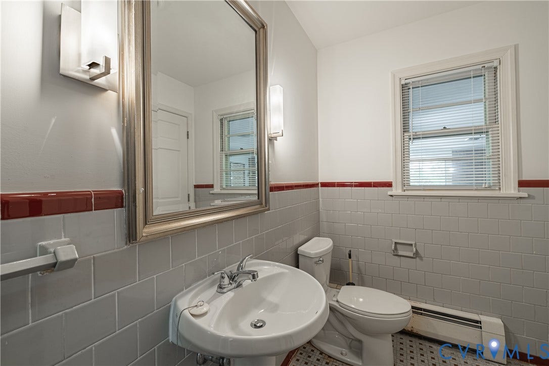 4532 Arrowhead Road, Statford Hills / Oxford, Richmond, VA 23235 Pedestal sink with chrome faucet, framed mirror, and wall-mounted sconces