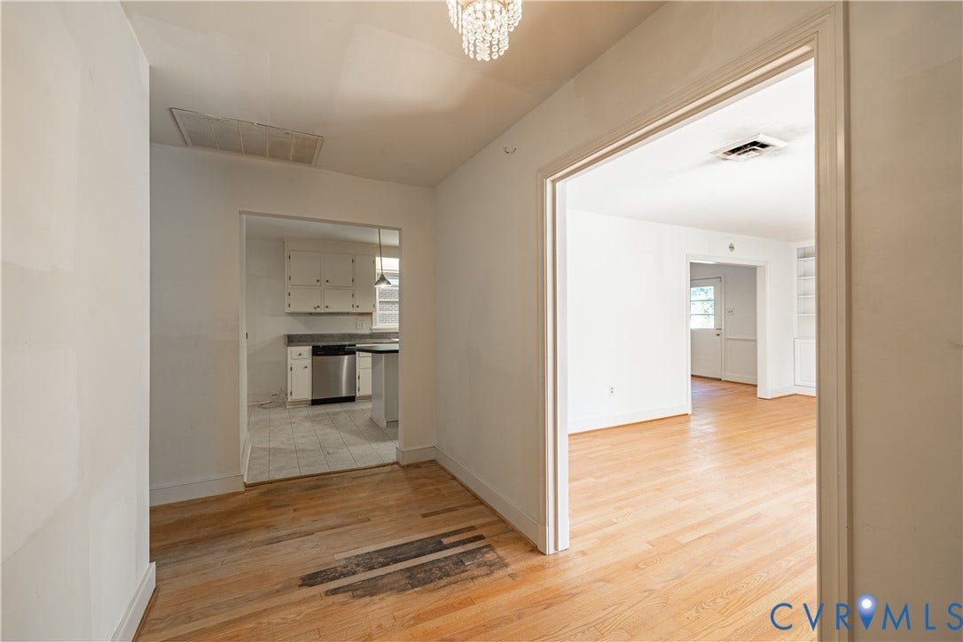 4532 Arrowhead Road, Statford Hills / Oxford, Richmond, VA 23235 Hardwood flooring throughout, white painted walls, and a crystal chandelier