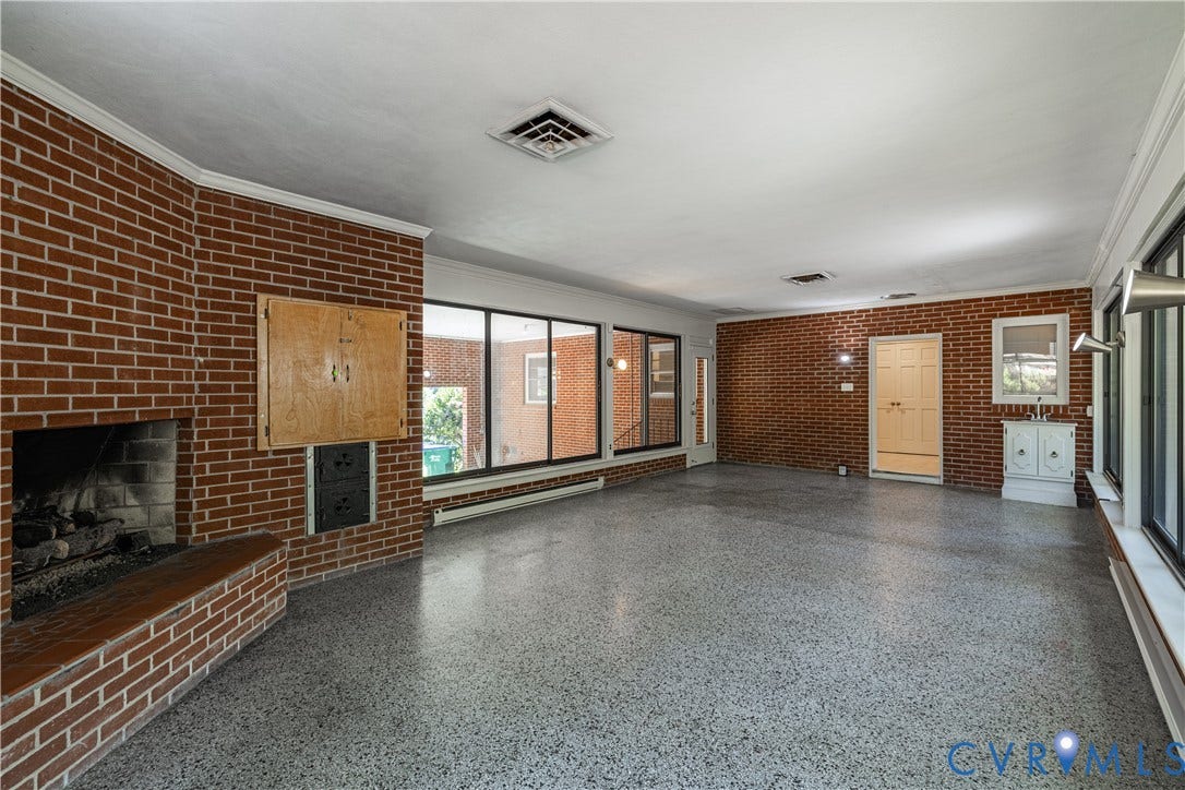 4532 Arrowhead Road, Statford Hills / Oxford, Richmond, VA 23235 Brick accent walls and a wood-burning fireplace with a brick hearth